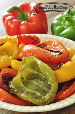 Multicolored bell pepper halves with blistered skin in a bowl. 