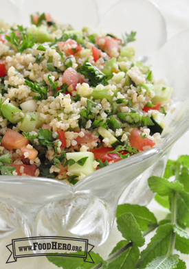 Bowl of vegetables with bulgur and dressing.