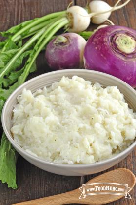Bowl of seasoned and mashed potatoes and turnips.