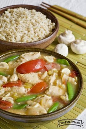 Medium bowl of chicken, pineapple and vegetables in broth served with rice. 