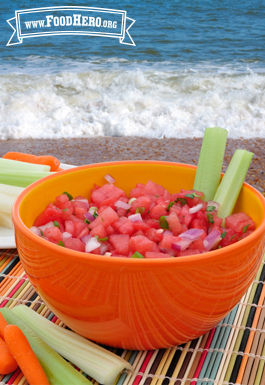 Bowl of watermelon cubes with cilantro dressing.