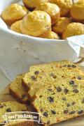 Moist carrot and raisin muffins and sliced bread.
