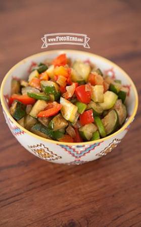 Small bowl with a tender zucchini and vegetable mix.