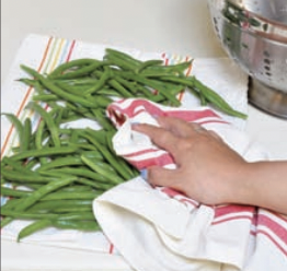 Green beans being pat dry.
