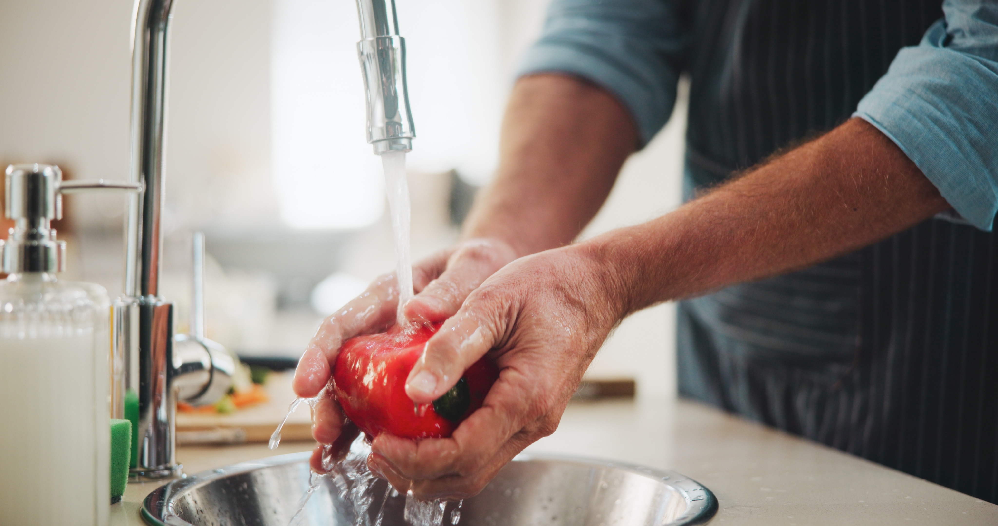 Man washing tomato