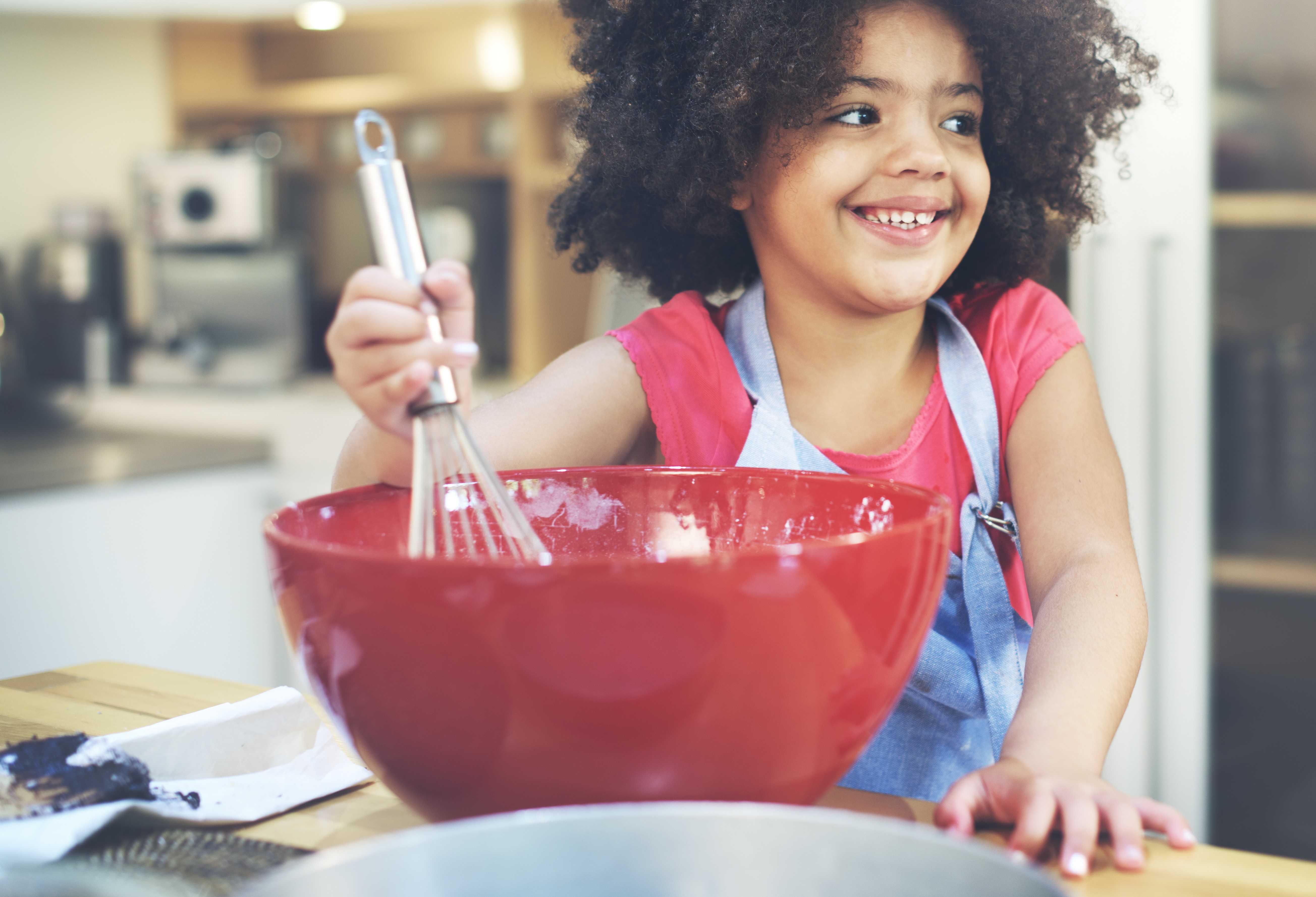 young girl mixing ingredients in bowl