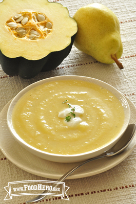 A bowl of smooth squash soup spiced with ginger and garlic is topped with yogurt and chopped parsley.