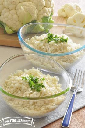 Two bowls of grated cauliflower garnished with parsley.