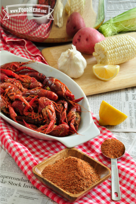 Creole seasoning mix shown with crawfish, lemon, potato and corn.