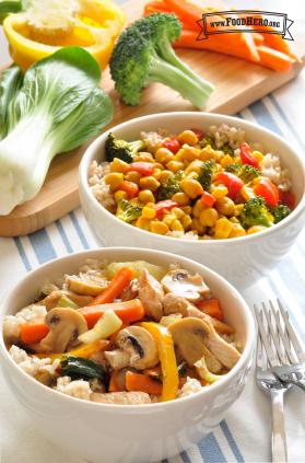 Two bowls with rice and a variety of stir-fried vegetables.