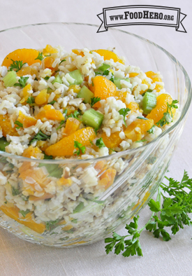 Big bowl of a colorful mixture of rice, orange and parsley.