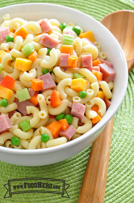 Macaroni noodles with ham, vegetables and dressing.