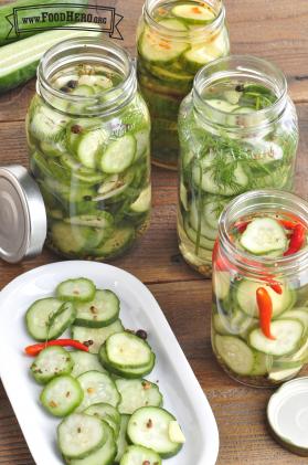Sliced cucumbers in mason jars with pickling brine. 