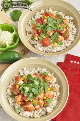 Bowls of rice with chicken and vegetables topped with cilantro.