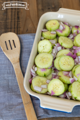 Platter of seasoned cucumber and red onion slices.