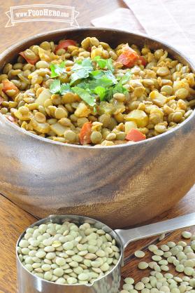 Bowl of seasoned lentils with vegetables garnished with cilantro.