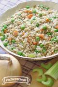 Mix of bulgur with savory vegetables is displayed in a serving dish.