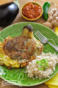 Plate of pan-fried eggplant omelet served with rice.