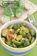 Bowl of seasoned and browned brussels sprout halves. 