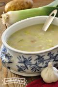 Oval ceramic serving dish with potato leek soup.