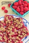 Plate of square red oatmeal and raspberry bars. 