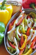 Bowl of tender bell pepper and onion slices.