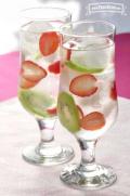 Glasses of water with strawberry and kiwi slices.