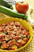 Bowl of baked zucchini with a cheesy tomato sauce.