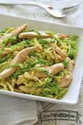 Green cabbage with strips of chicken on a plate.