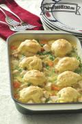 Baking dish of dumplings with a saucy chicken and vegetable base.