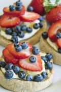 Cream cheese spread on English muffins with a fresh fruit topping.