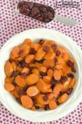 Tender carrot slices with dried cranberries in a small bowl.