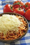 Big bowl of spaghetti topped with grated parmesan cheese.
