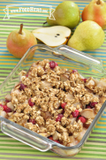 Baking dish of baked pear and cranberries with an oat topping. 