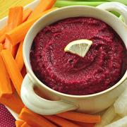 Display of Beet Dip recipe served with vegetable slices and lemon 