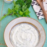 Small bowl of a creamy, white sauce. 