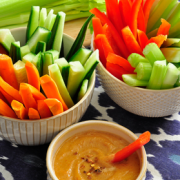 Bowl of Peanut Sauce shown with bowls of raw vegetables for dipping.