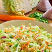 Shallow bowl of pickled cabbage and sliced vegetables.