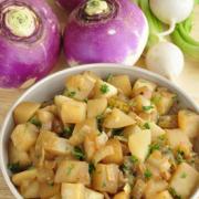 Bowl of browned turnips with parsley. 