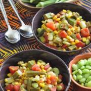 Bowls filled with a variety of vegetables and okra. 