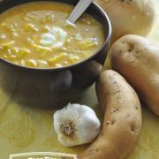 Bowl of orange, creamy soup with a dallop of sour cream 