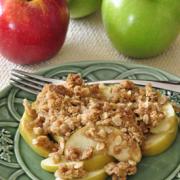 Plate of baked sliced apples with a sweet granola topping.