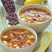 Bean, corn and summer squash soup in bowls.