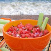 Bowl of watermelon cubes with cilantro dressing.