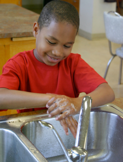 Boy demonstrating how to wash hands