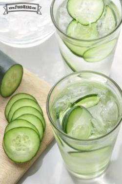 Glasses of ice water with thin slices of cucumber.