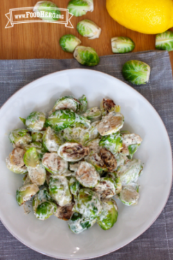 Plate of brussels sprouts with a creamy yogurt dressing.