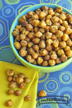 Bowl filled to the brim with baked and seasoned garbanzo beans.