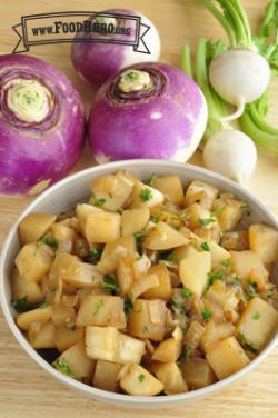 Bowl of browned turnips with parsley. 