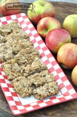 Baked Apple Bars with oatmeal crumble on top are displayed on a platter.